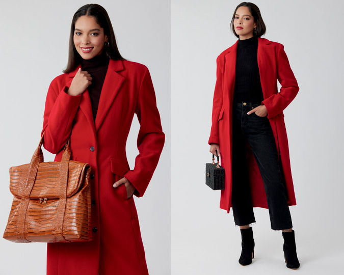 Model wearing a red coat, holding a brown bag, styled with black outfit.