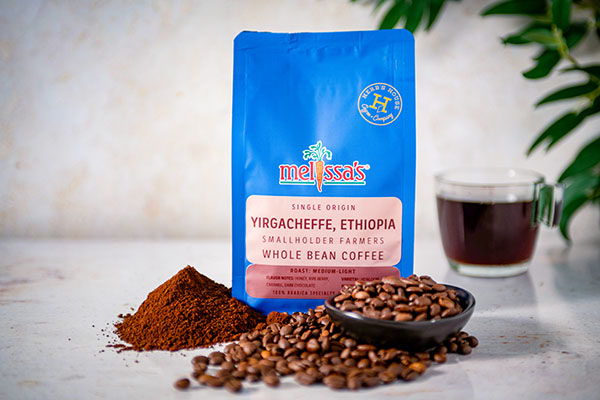 Coffee bag, ground coffee, coffee beans, and a cup of coffee.