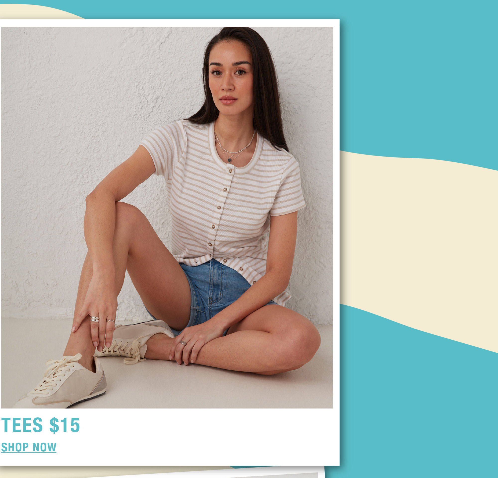 Young woman sitting, wearing a striped shirt and denim shorts.