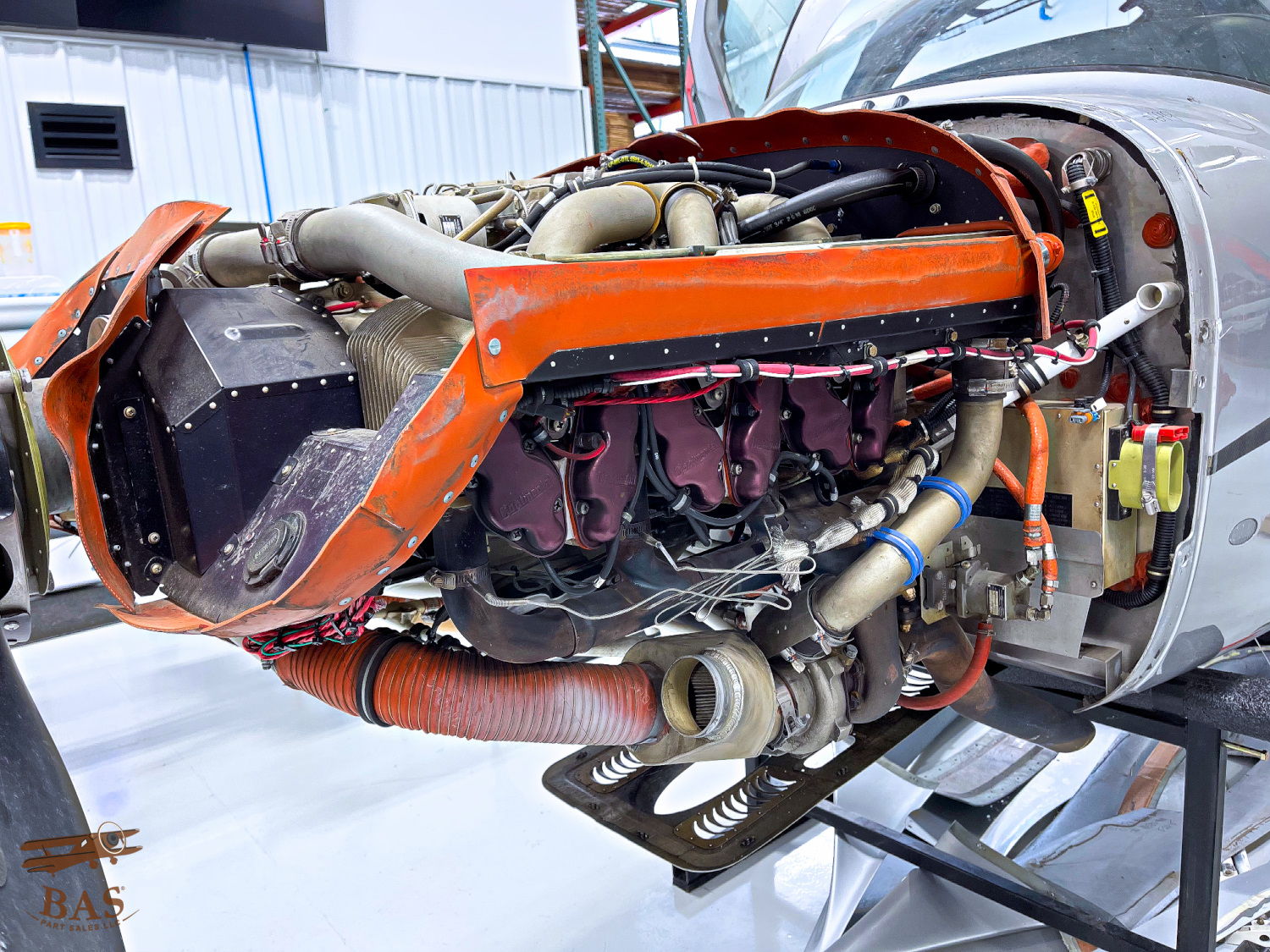 Aircraft engine disassembled, showcasing internal components and orange casing.