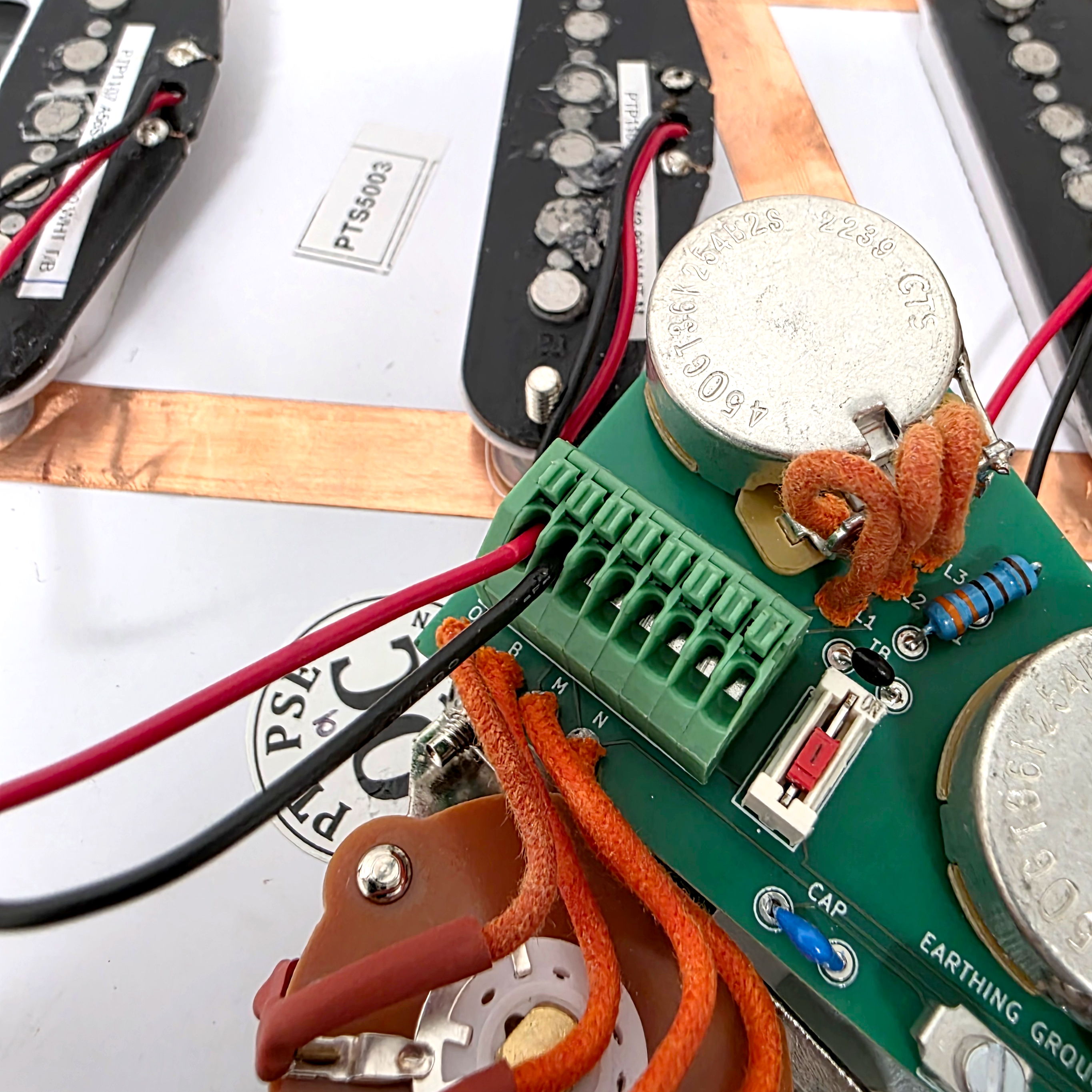 Close-up of a circuit board with wires and electronic components.