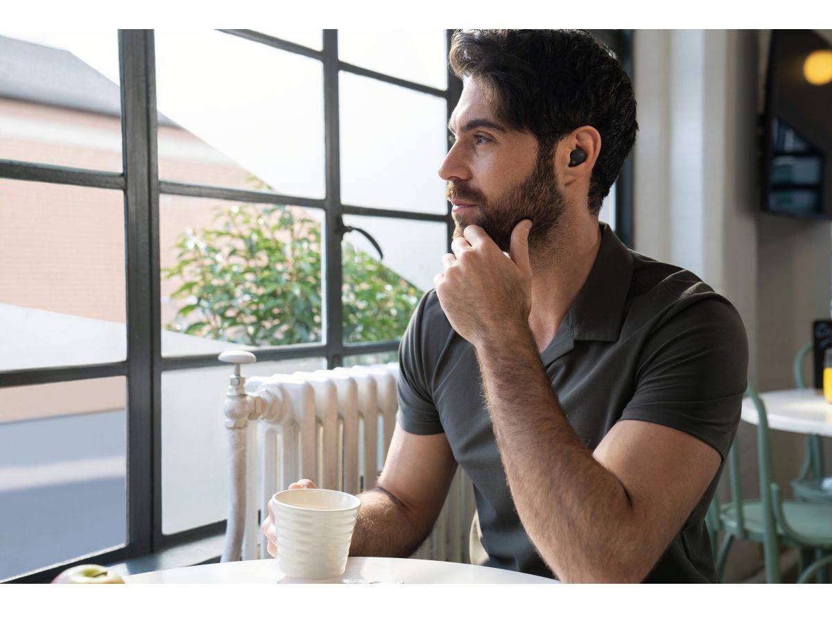 Man drinking coffee with XM5