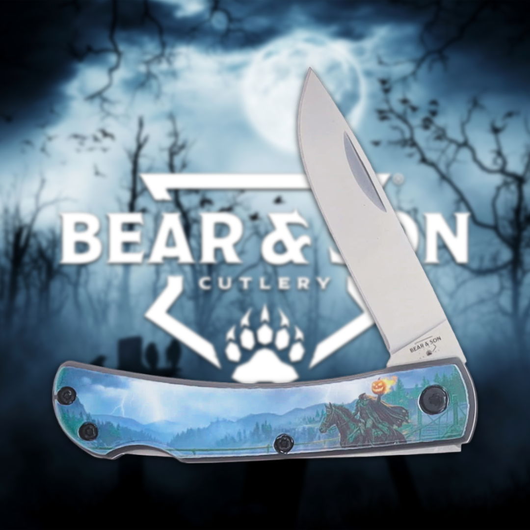 A folding knife with a decorative handle in front of a forest background.