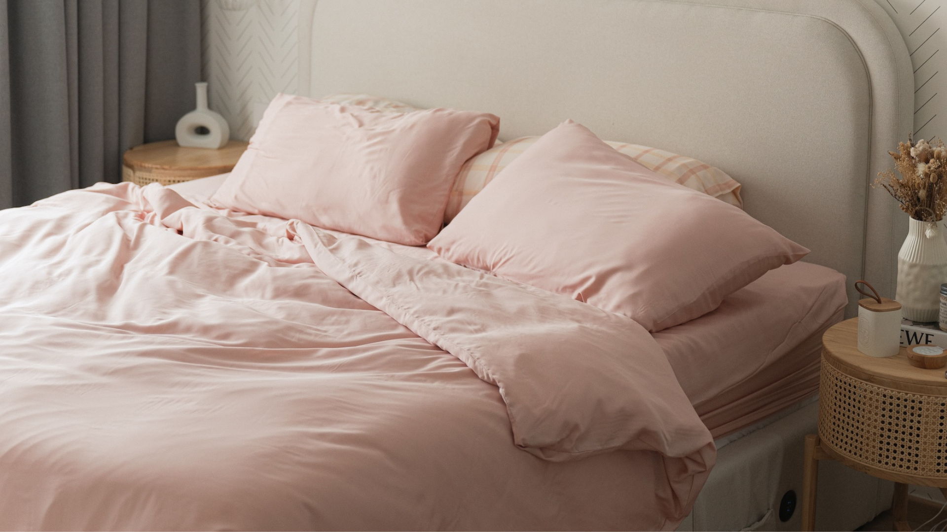 pink bedsheets with grey headboard