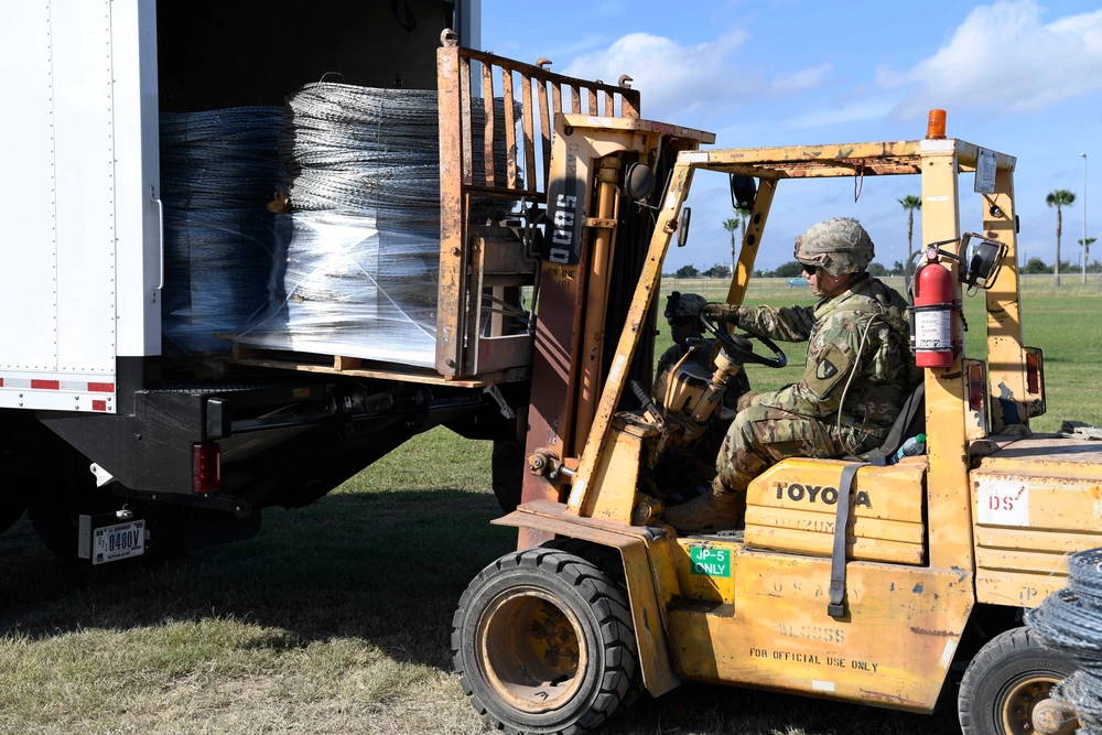 A Soldier operates a forklift to load concertina wire into a truck Nov. 5, 2018, which will be taken to the Anzalduas International Bridge, Texas. U.S Northern Command is providing military support to the Department of Homeland Security and U.S. Customs and Border Protection to secure the southern border of the United States.. (US Air Force photo by Airman First Class Daniel A. Hernandez)