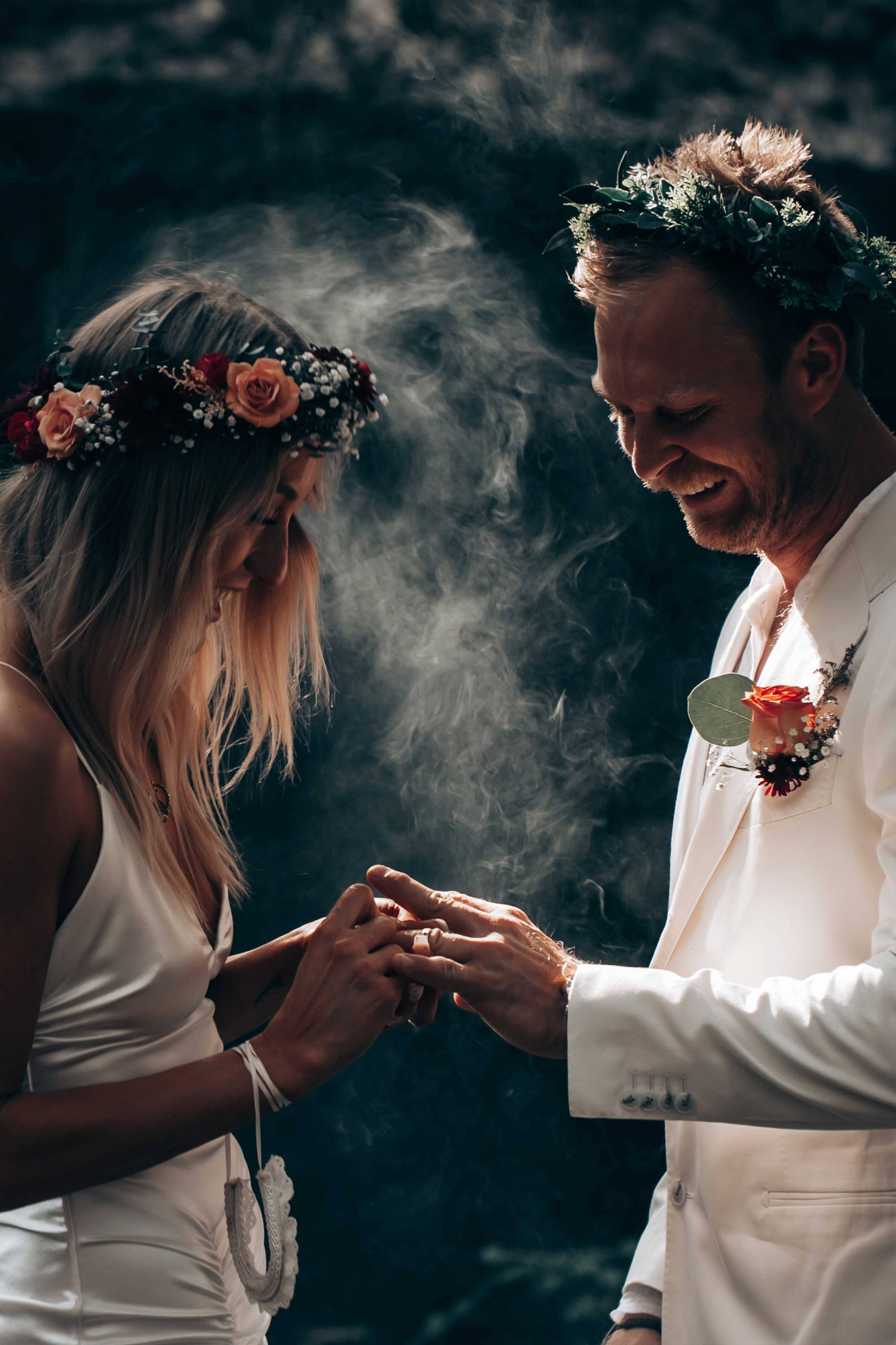 Groom putting ring on bride's finger