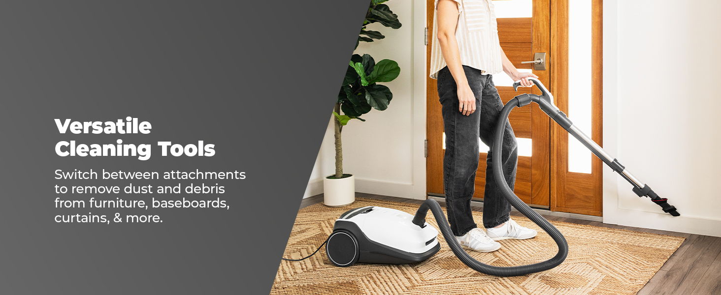 Person using a vacuum cleaner in a home setting.