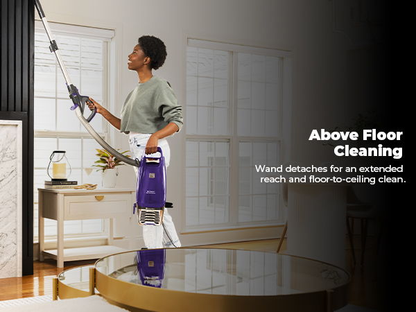 Person using a cleaning device for above floor cleaning in a modern room.