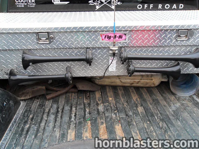 Close-up of dual horn layout mounted across the rear toolbox panel