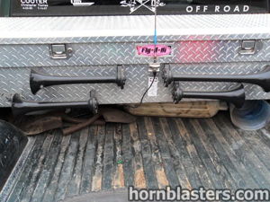 Close-up of dual horn layout mounted across the rear toolbox panel