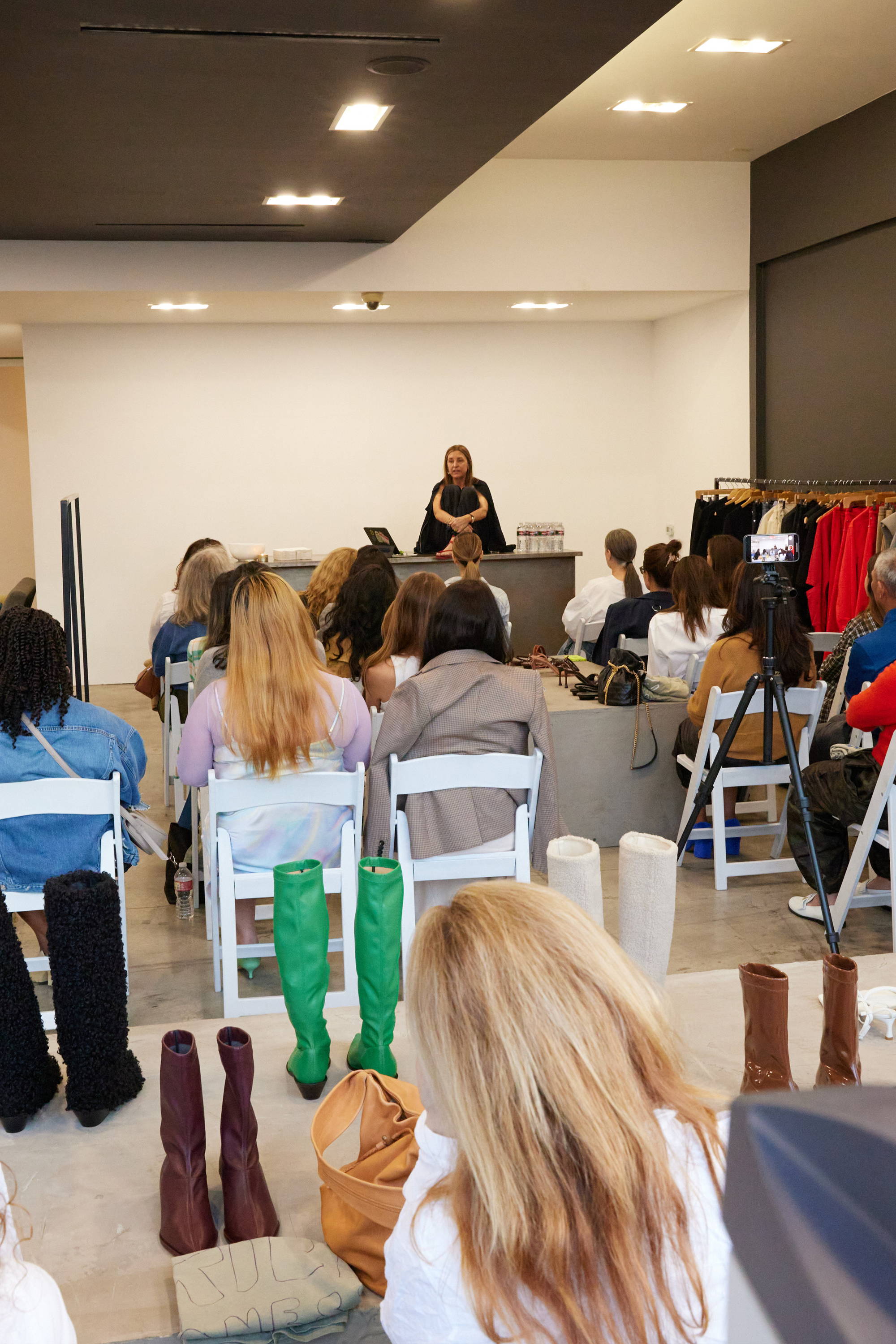 A group of people attending a presentation in a fashion setting.