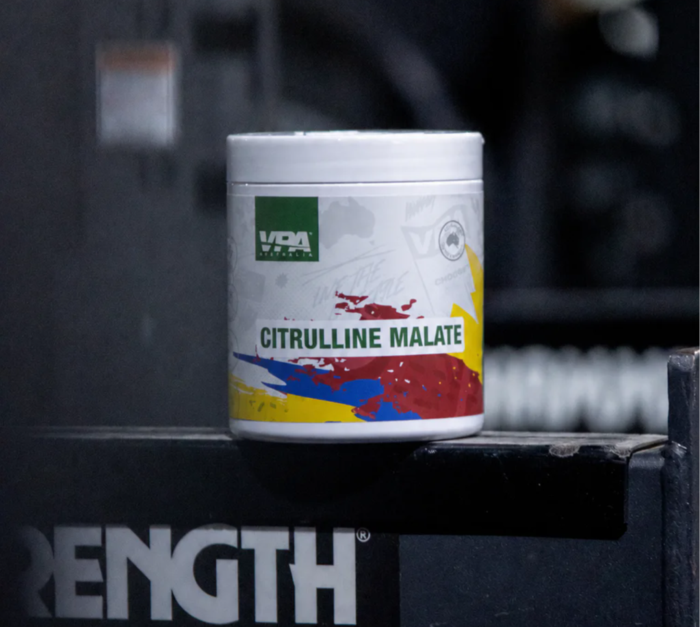 Container of Citrulline Malate on a gym equipment shelf.