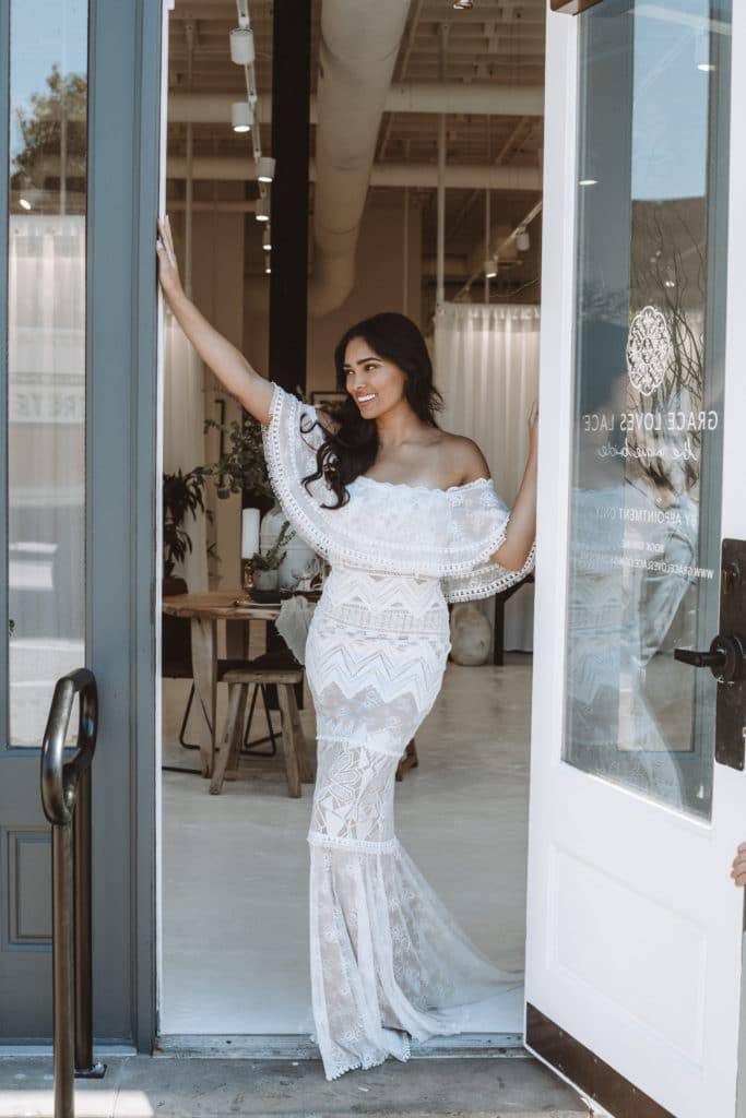 Bride in the entrance to the Minneapolis Grace Loves Lace bridal showroom wearing the Emanuela gown 