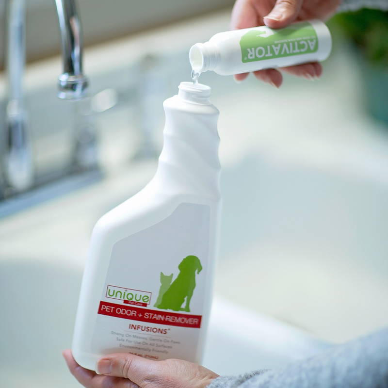refilling bottle of Unique Pet Care Infusions pet odor and stain remover with eco-friendly refill activator bottle