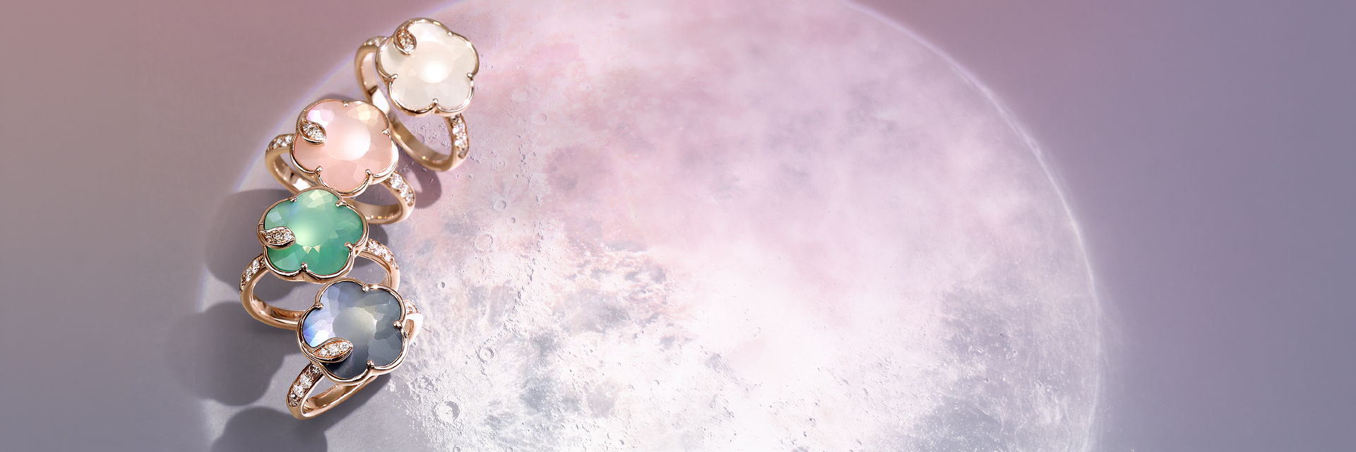 Colorful rings gemstones near a large, glowing moon in a purple background.