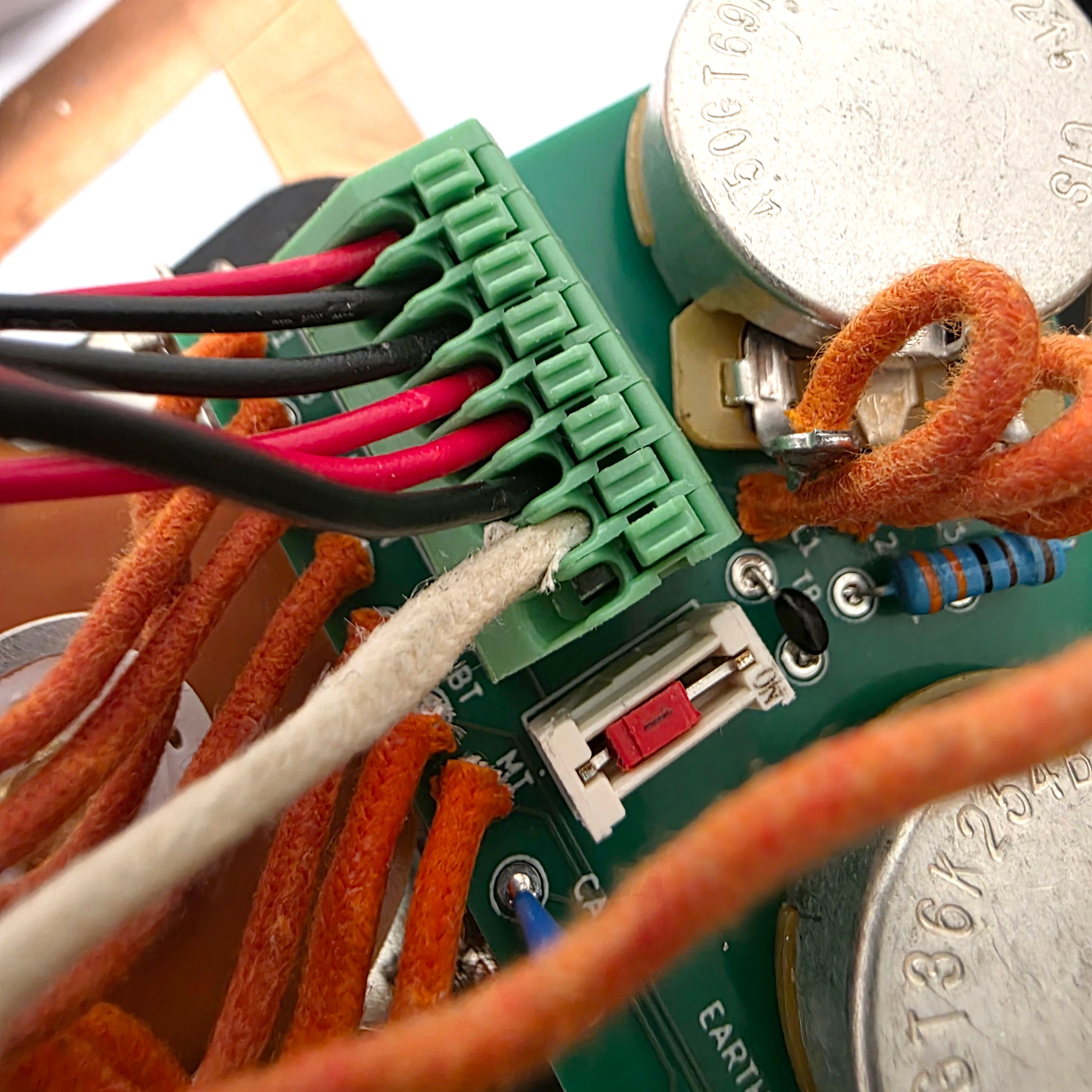 Close-up of a circuit board with colorful wires and connectors.