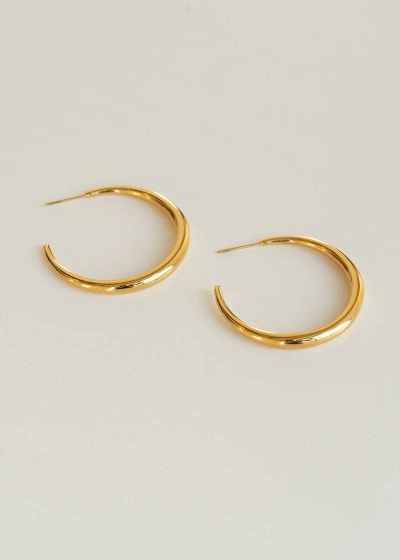 A pair of gold, half hoop earrings