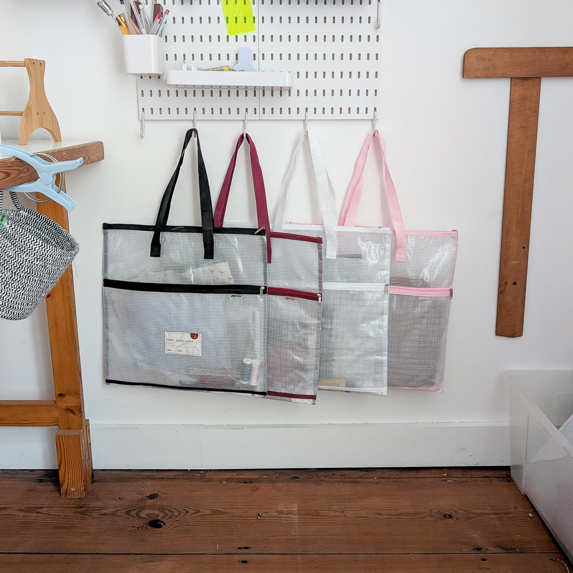 four project bags hanging on a peg board