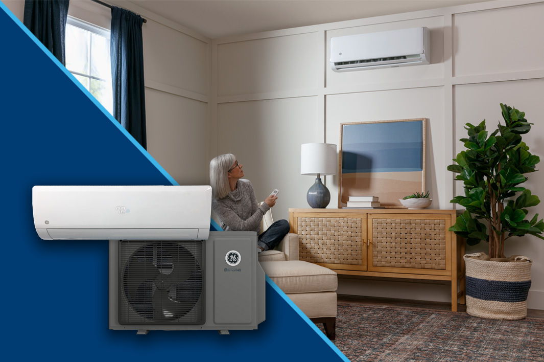 Person sitting on a couch with an air conditioning unit in a living room.