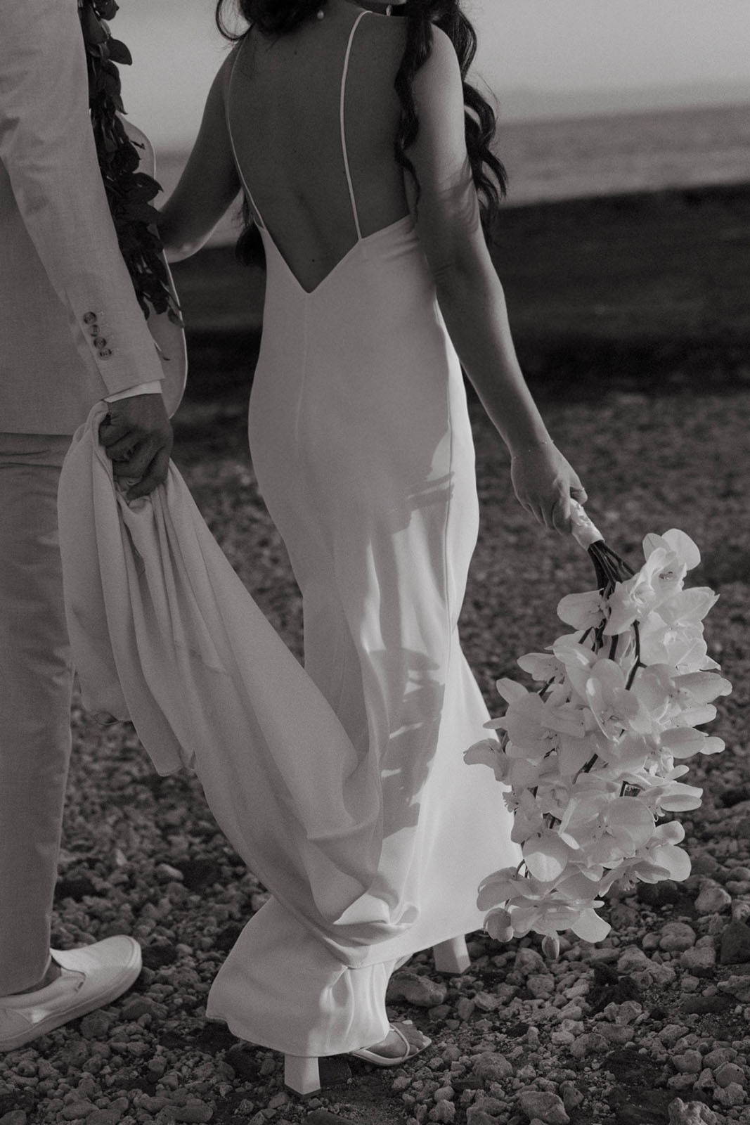 Black and white image of bride wearing the Summer gown on beach in Hawaii