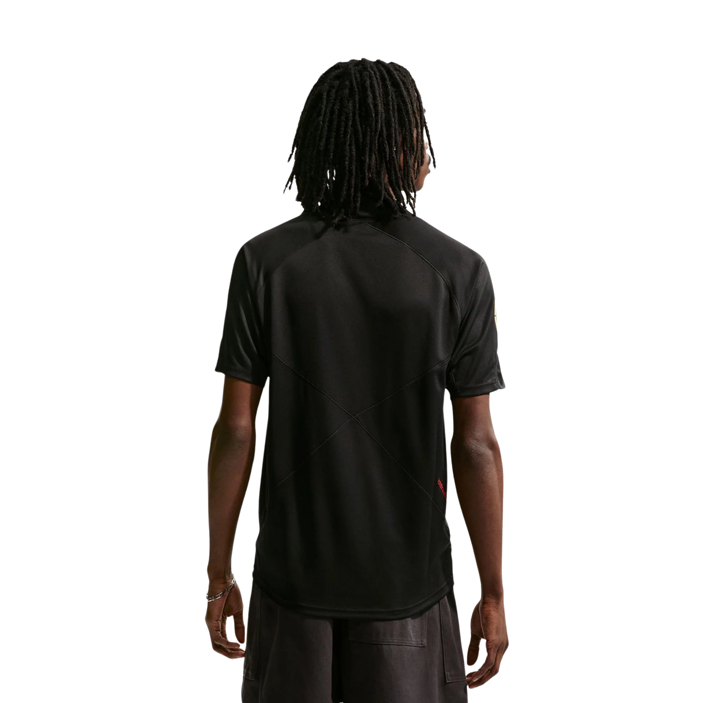 Person wearing a black t-shirt with a circular design, standing against a plain background.