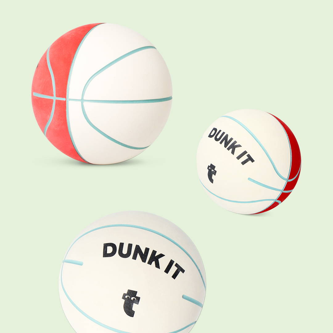 Three different basketballs in white, red, and cream colors, each with unique markings, one marked 'DUNK IT'