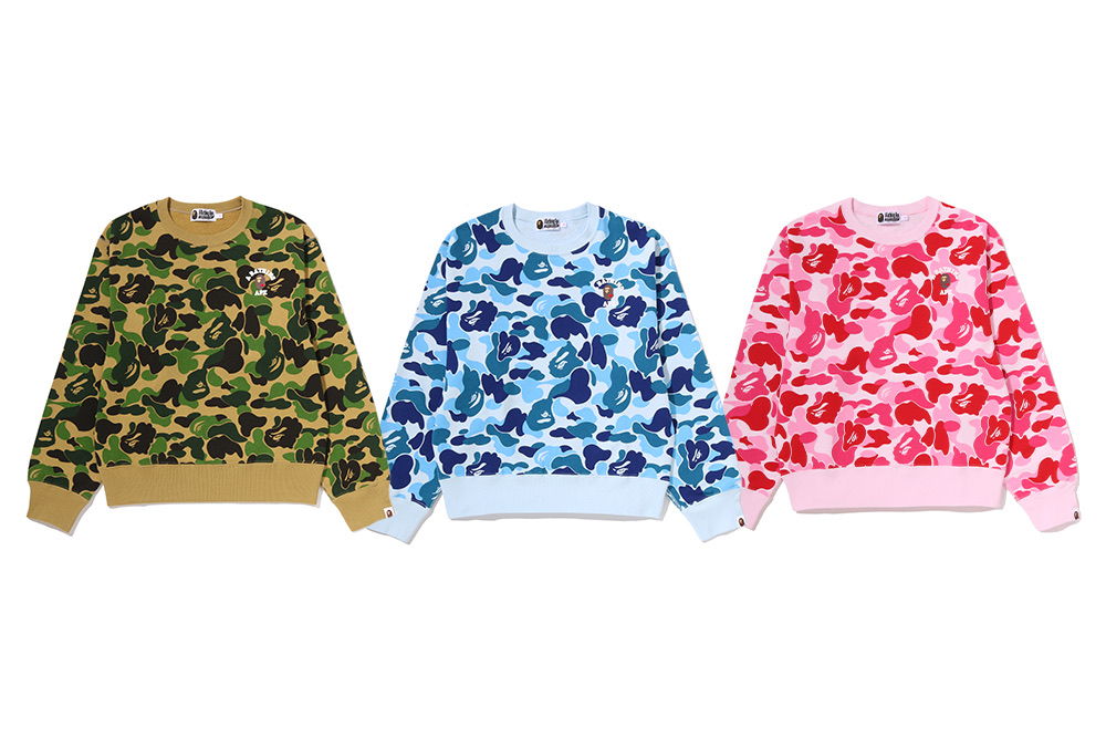 Three patterned sweatshirts in green, blue, and pink colors.