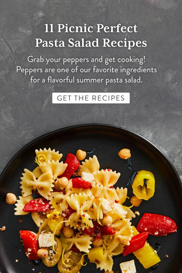 Farfalle pasta with peppers, chick peas, feat and olives served on a plate