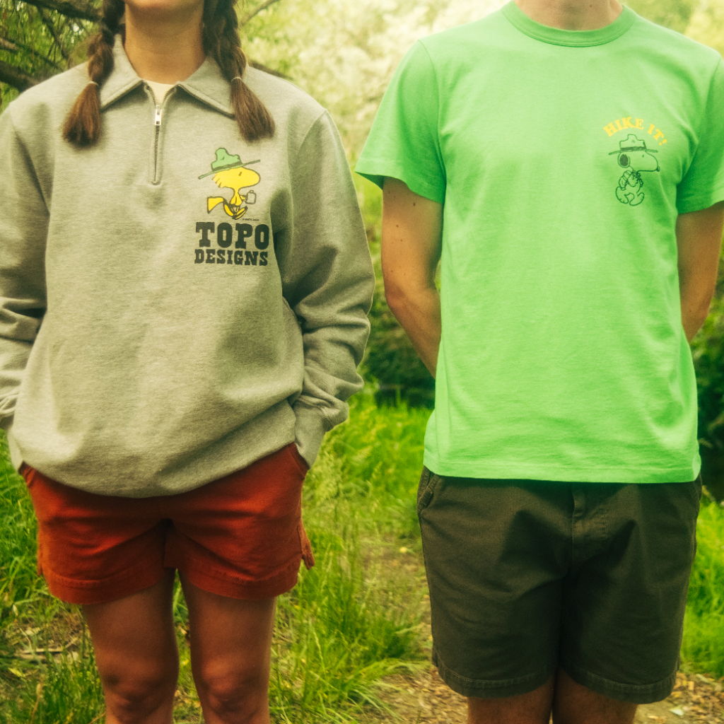 Two people standing side by side in casual outdoor clothing.