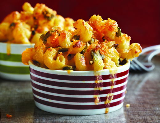 Two bowls of macaroni and cheese with toppings.