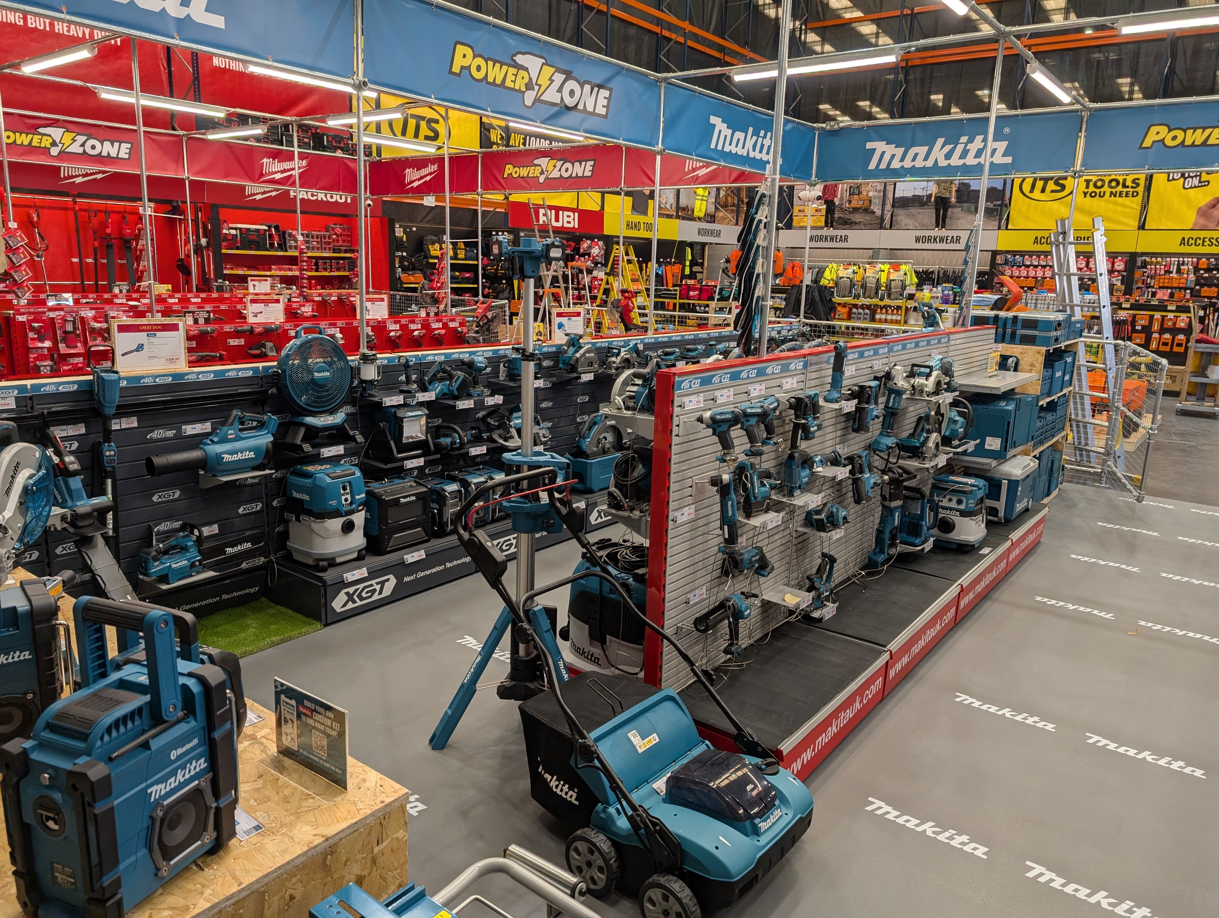 Display of various power tools in a brightly colored store.