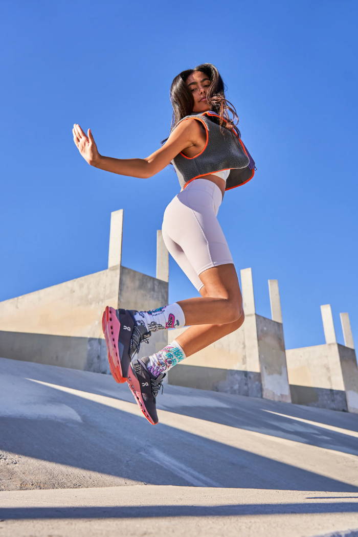 female model jumping in on running shoes