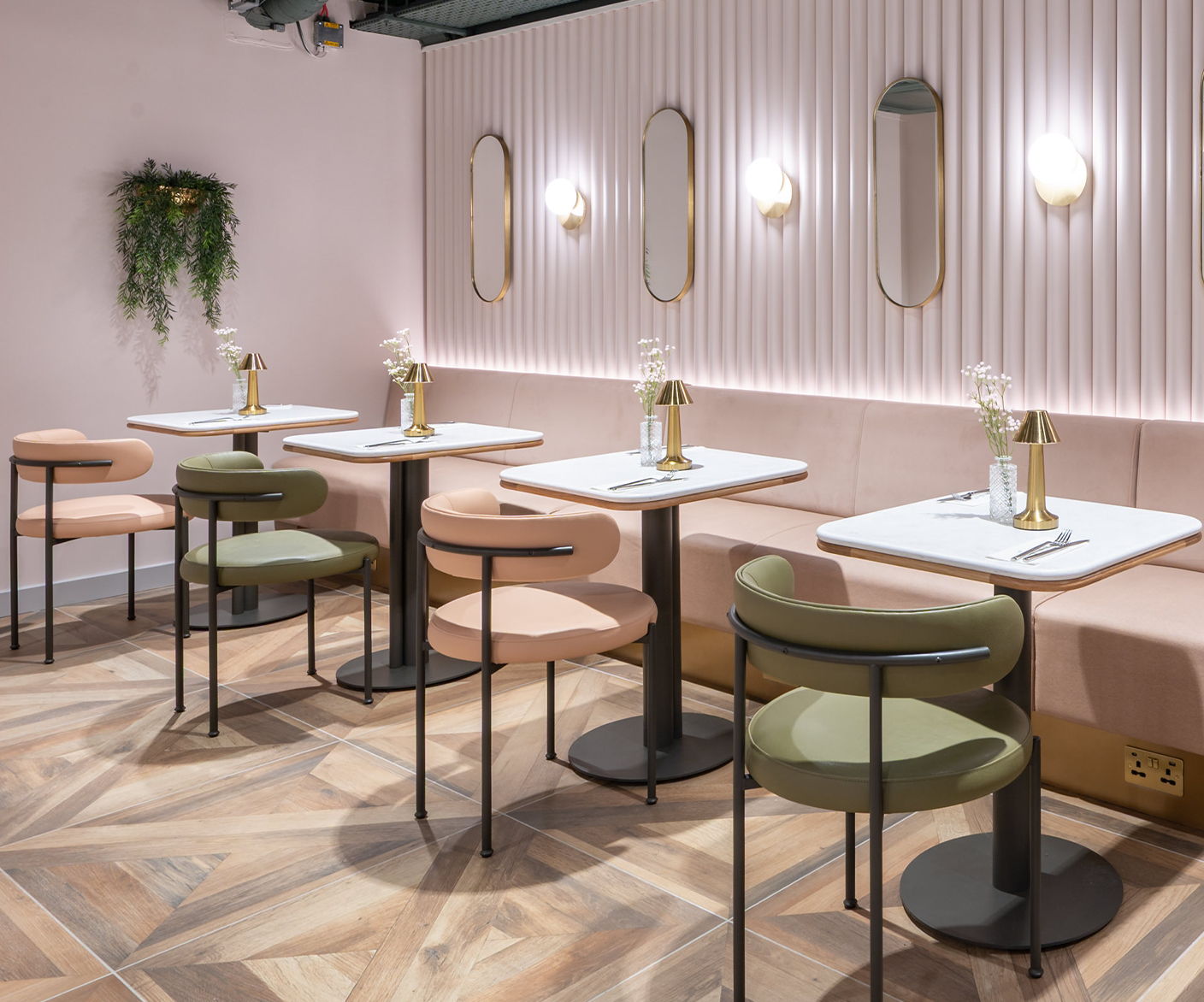 Modern cafe interior with pastel colors, tables, and stylish seating.