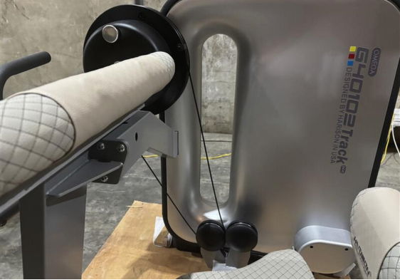 Close-up of a machine with a fabric roll and control panel.
