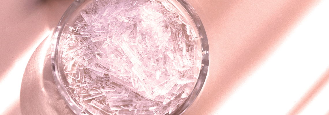 Close-up of a glass filled with clear liquid and ice.