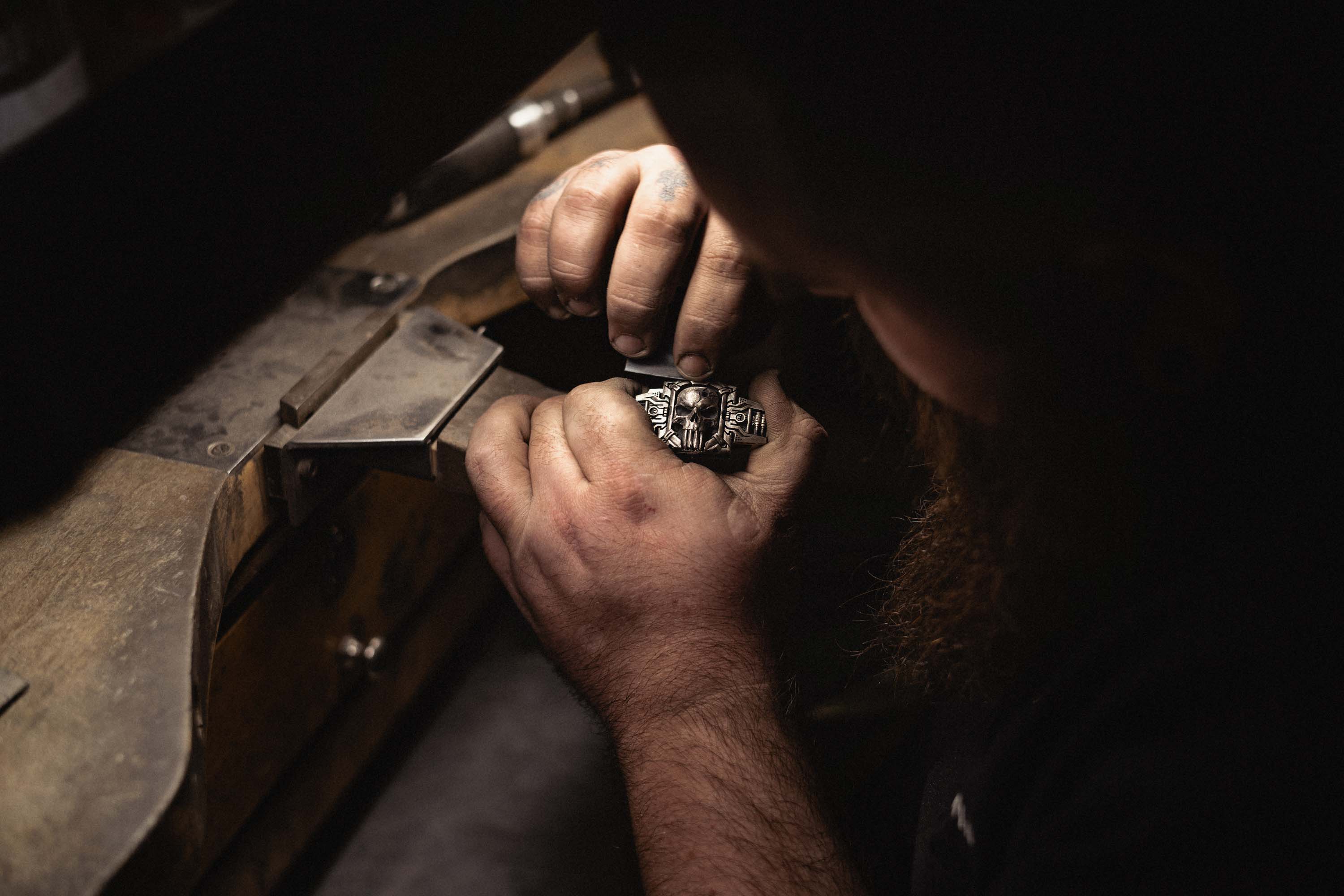 A NightRider Master Jeweler works on the details of a Sheepdog Interlock Bracelet