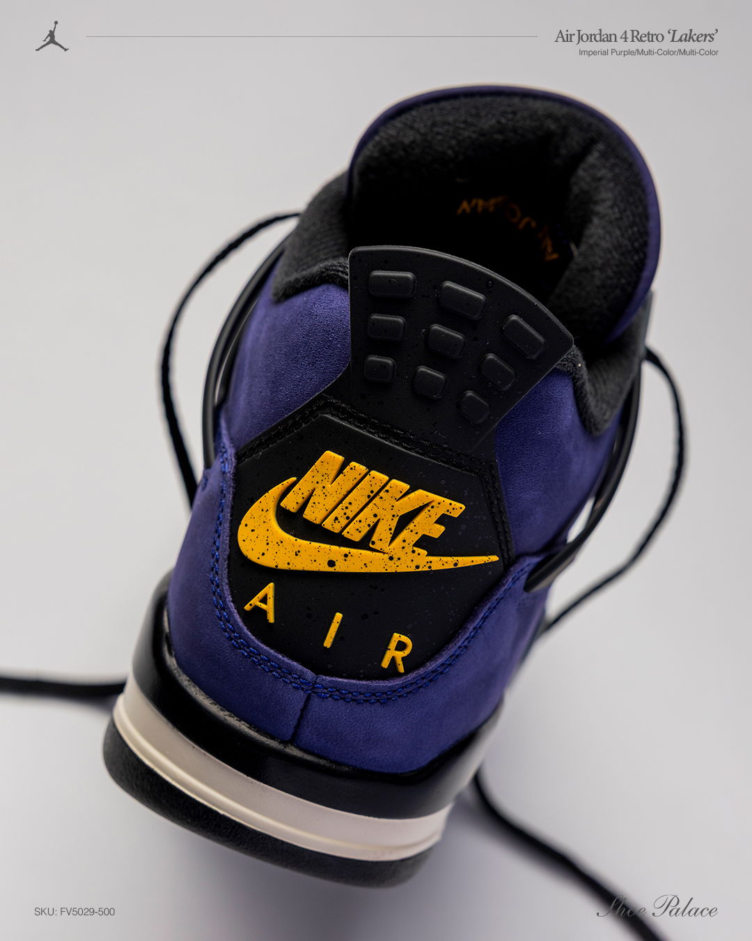 A close-up of a purple Nike Air shoe's heel with logo.