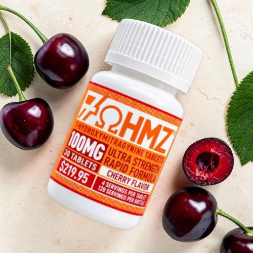 Bottle of cherry-flavored supplement surrounded by fresh cherries.