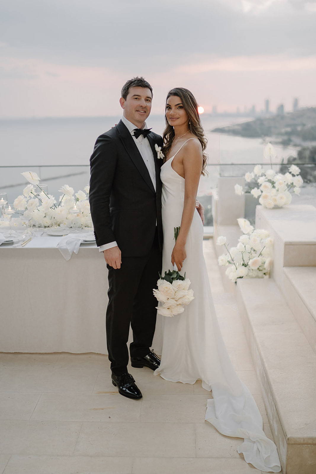 Bride and Groom standing and smiling at the camera