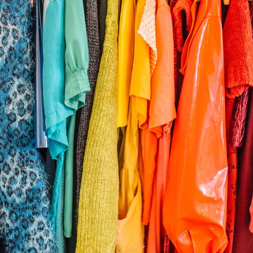 Colorful clothing hanging on a rack.
