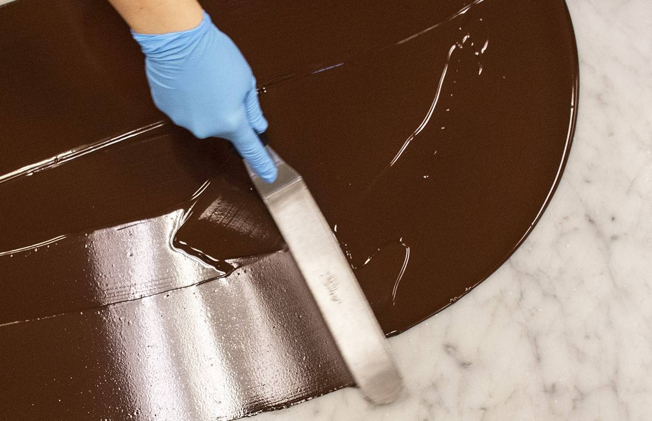 Chocolate being tempered on stone table top