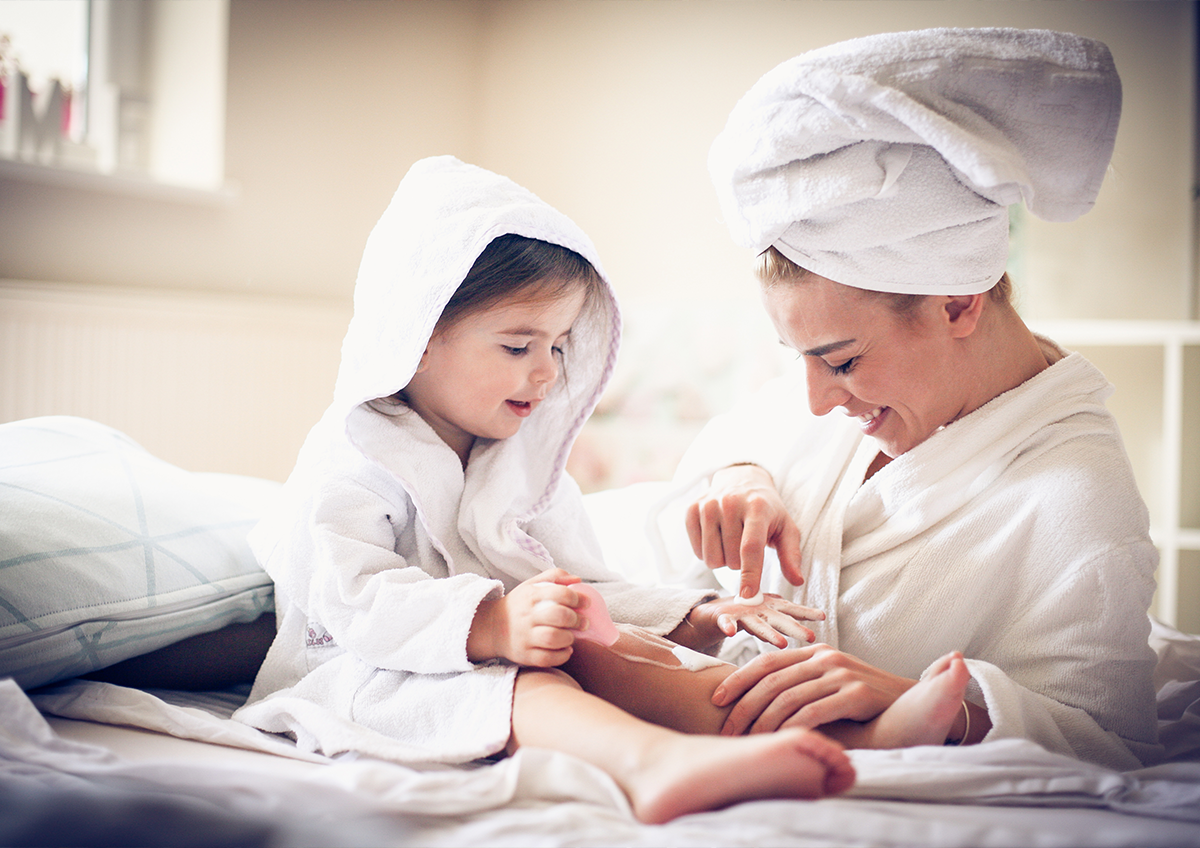 Mom and toddler applying lotion