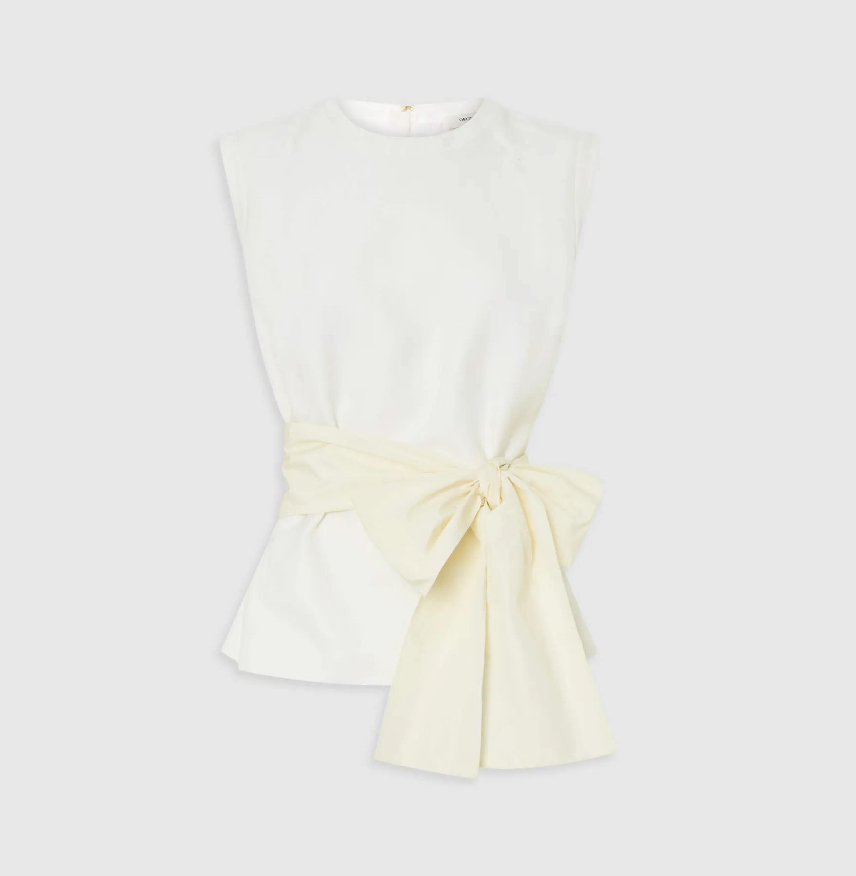 White sleeveless top with a large bow detail at the waist.