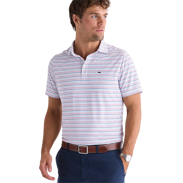 Man in striped polo shirt and navy pants, standing confidently.