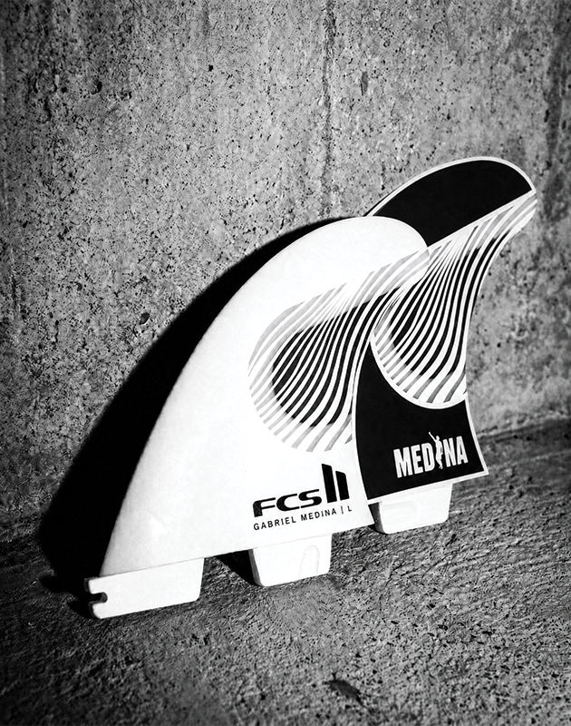 Two surfboard fins in black and white against a concrete background.