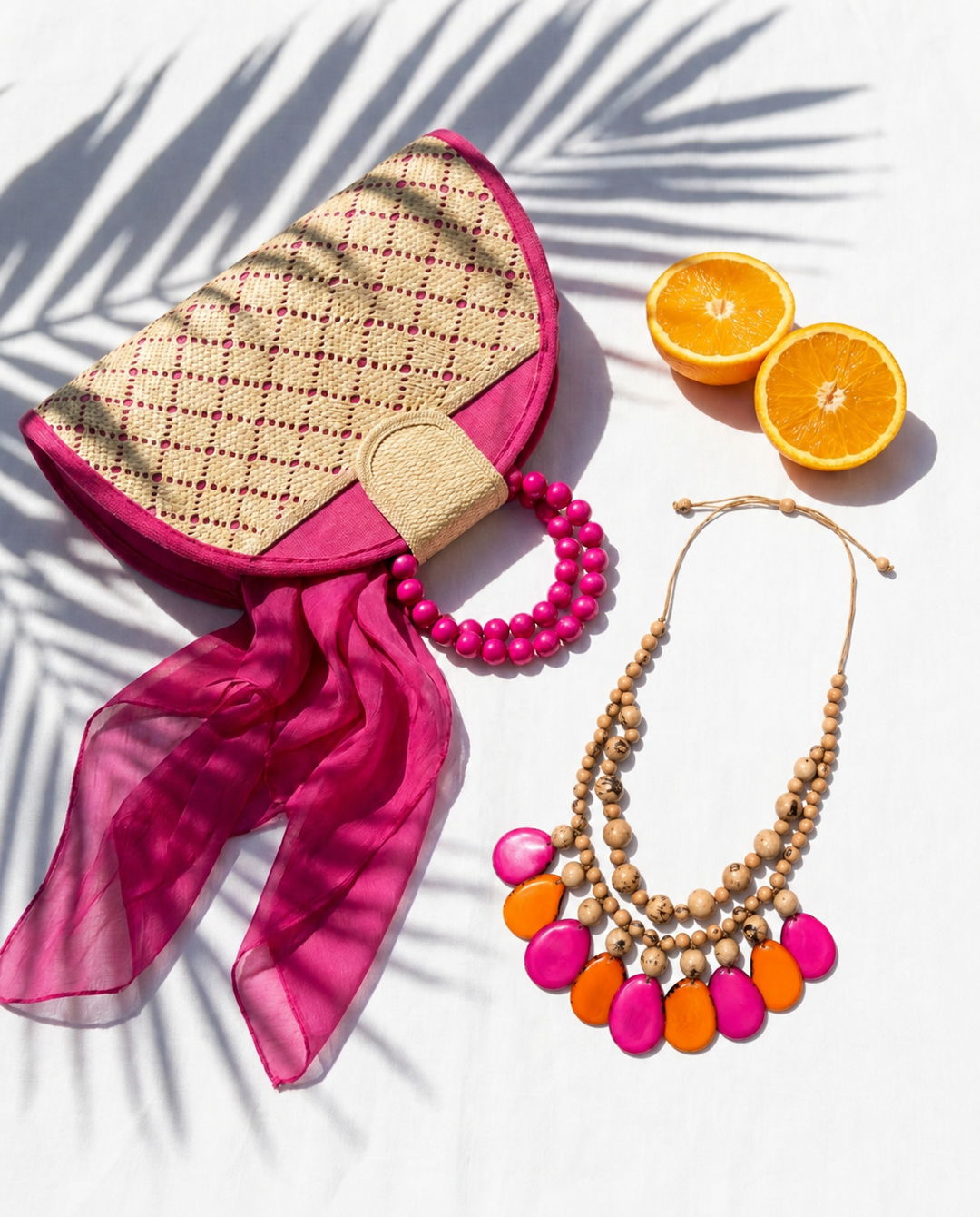 Colorful Tagua jewelry flat lay with oranges and accessories