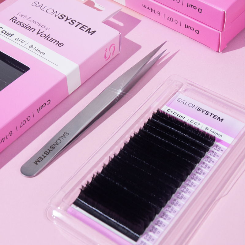 Eyelash extension supplies including tweezers and volume lash trays on a pink background.
