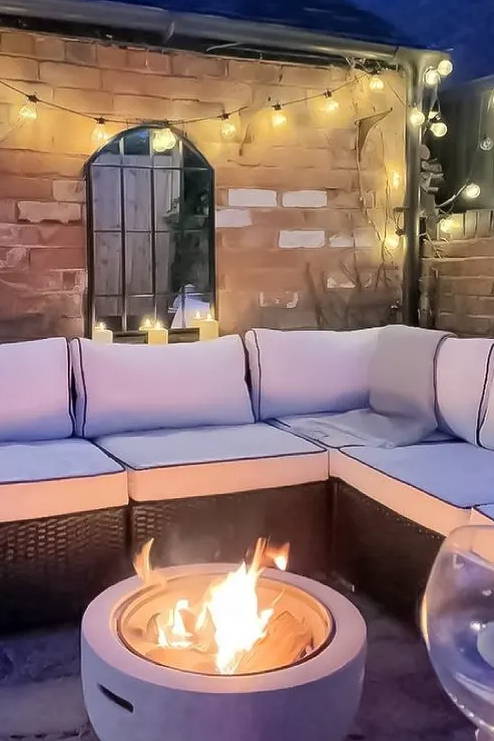 Customers balcony photo displaying festoons and candles with a firepit