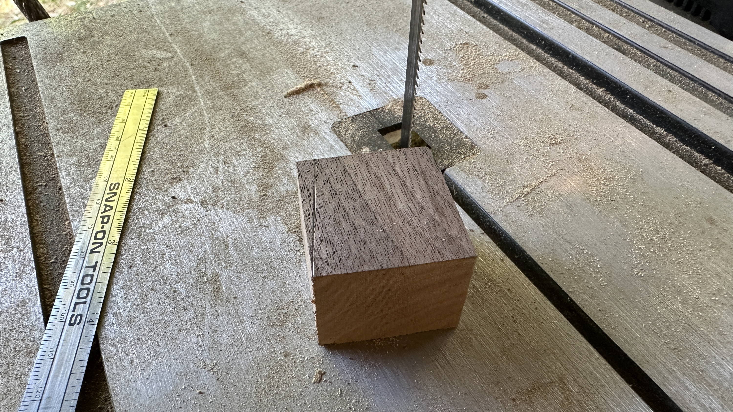 block of walnut and bandsaw ready to cut into a wedge