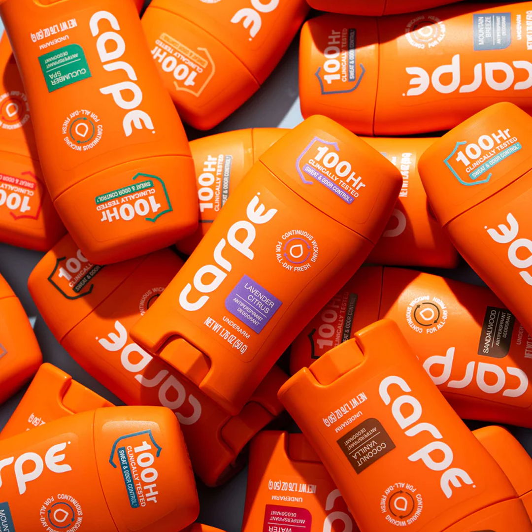 A collection of orange Carpe products stacked together.